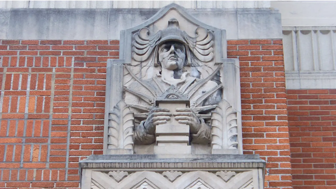 Architectural detail of the Clackamas County Courthouse entrance, showcasing the geometric fluting, recessed windows, and the 'Art Deco' interpretation of classical civic power in Oregon City.