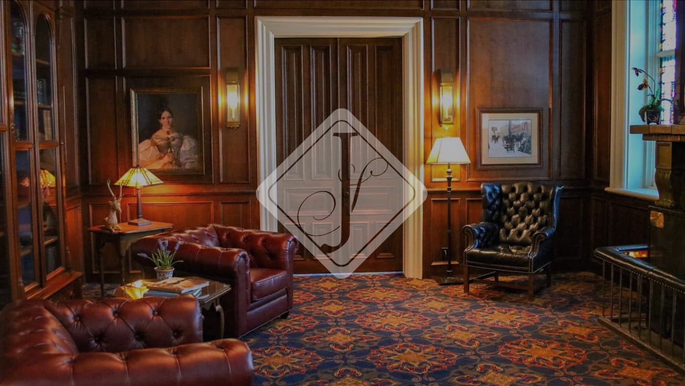 A wide exterior view of the historic St. James Hotel in Red Wing, MN. The four-story Italianate-style building, completed in 1875, is constructed of red brick with cream-colored stone window hoods and a decorative bracketed cornice.