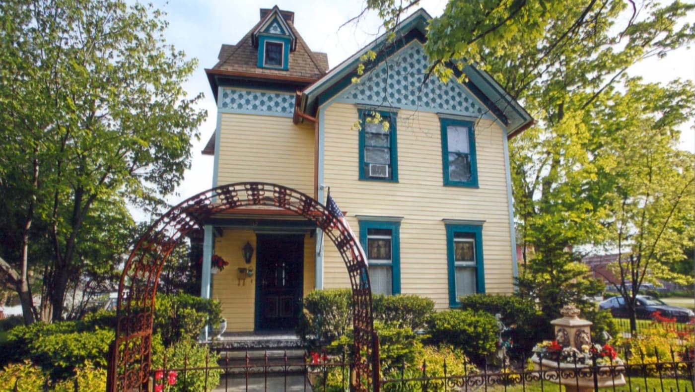 Front exterior view of the T.C. Smith Historic Inn in Lake Geneva, WI. Built in 1845 and expanded in 1865, the stately white mansion features a transition from Greek Revival to High Victorian Italianate architecture.