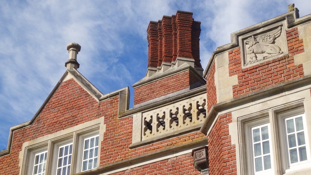 Griffin stone carving on the facade of the historic Eliot Hall at Reed College in Portland, Oregon.