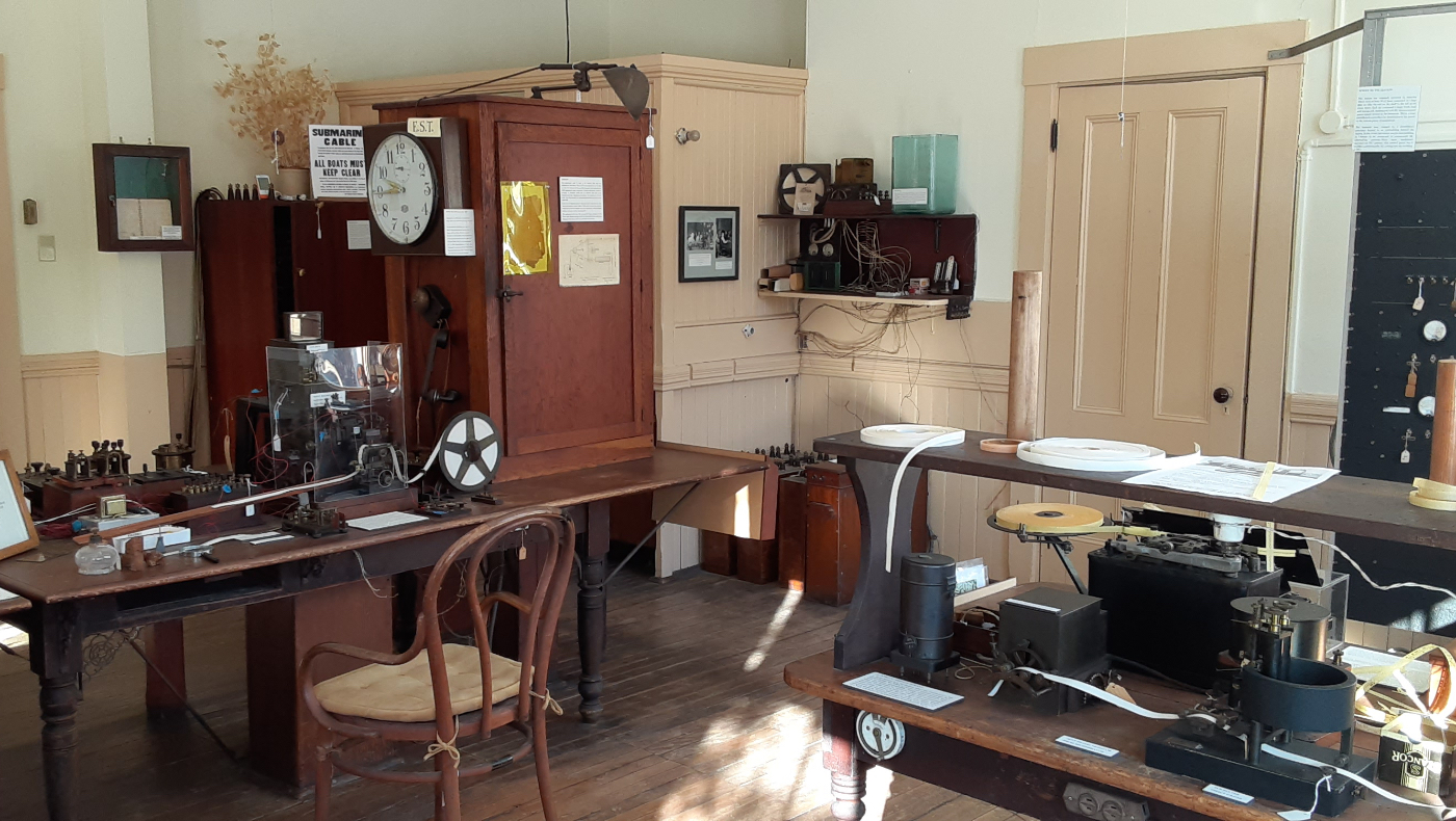 An interior view of the French Cable Station Museum in Orleans, MA, showcasing a historic telegraph and ocean cable communication room.