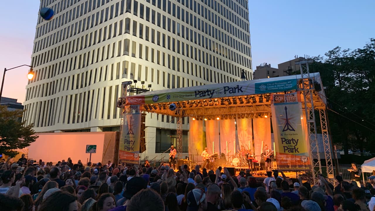 A large outdoor crowd gathered at sunset for the