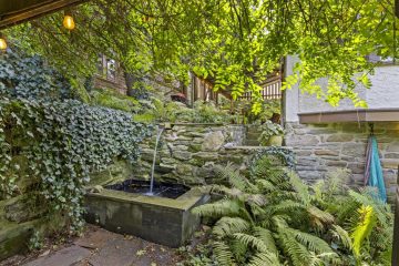 1938 Tudor Revival at 419 Lodges Lane, Elkins Park, Pennsylvania: garden pond and fountain beside the patio