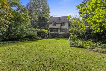 1938 Tudor Revival at 419 Lodges Lane, Elkins Park, Pennsylvania: rear yard looking back toward the house