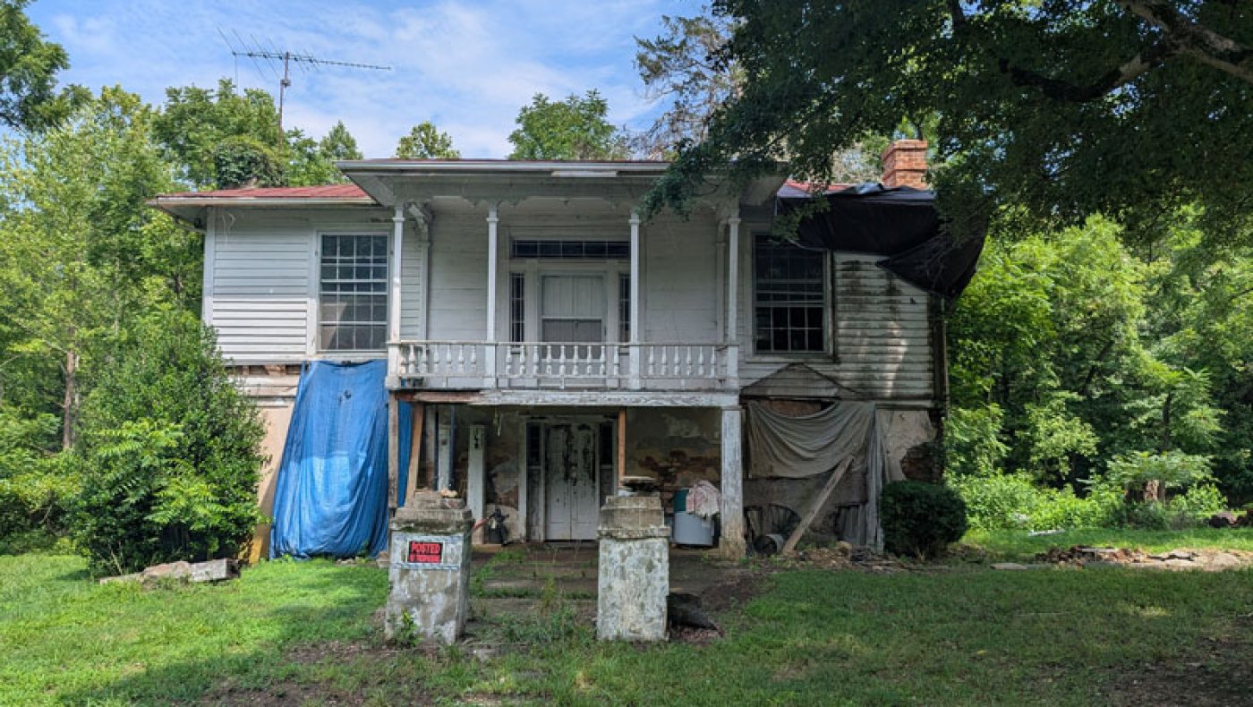 Gordon-Brandon House in Milton, North Carolina: raised Greek Revival cottage with a two-story front porch, brick lower level and masonry gate posts