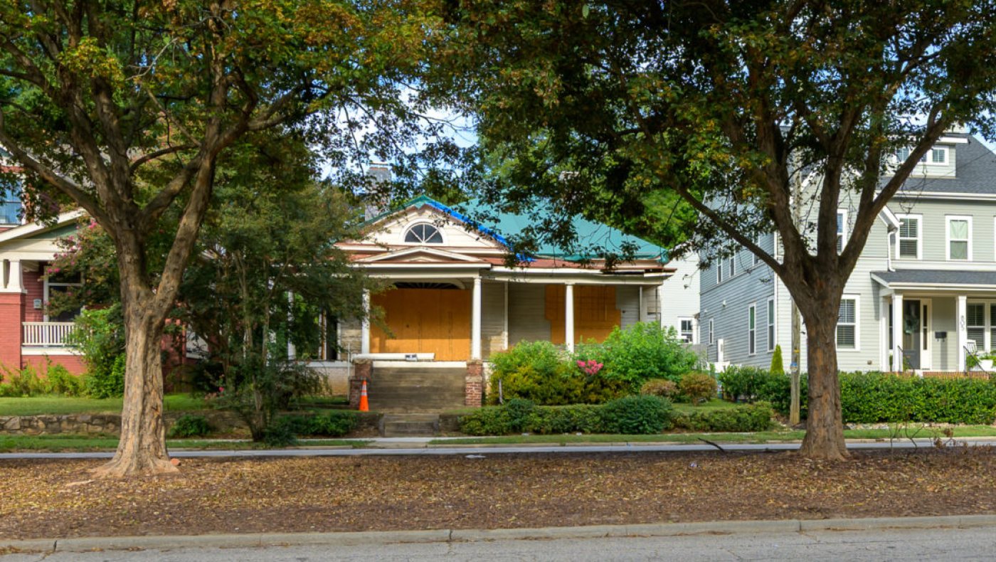 P. Edgar Furr House in Raleigh, North Carolina: 1913 house with a wraparound porch and fanlit front gable on tree-lined Glenwood Avenue